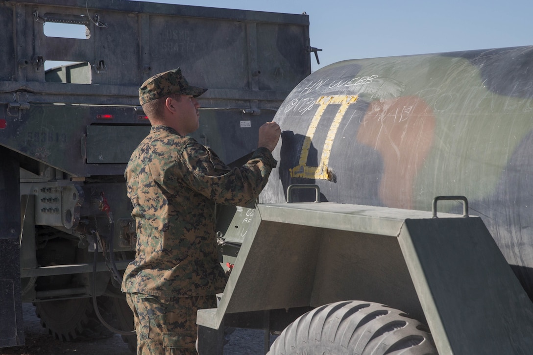 Seaman Kyler Webb, a hospital corpsman from the Naval Health Clinic, Corpus Christi, marks the water bowl “potable” with the time it was tested, during Integrated Training Exercise 4-18 in Marine Corps Air Ground Combat Center Twentynine Palms, Calif., June 17, 2018. MCAGCC Twentynine Palms has 28 water bowls placed throughout base for training during ITX 4-18. Each bowls holds 400 gallons of water and is tested twice daily to ensure proper amounts of chlorine are within the water. (U.S. Marine Corps photo by Lance Cpl. Samantha Schwoch/released)