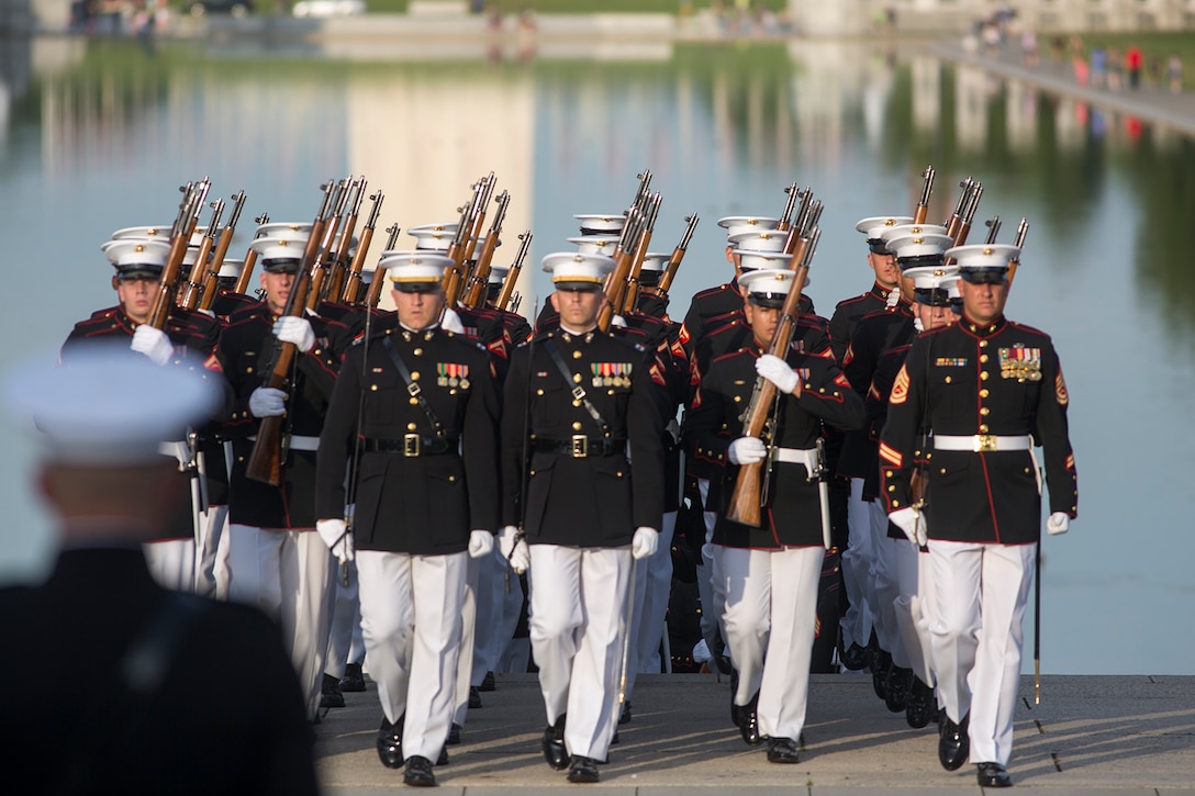 Marines with Bravo Company, Marine Barracks Washington D.C., march onto the parade deck during a Tuesday Sunset Parade at the Lincoln Memorial, Washington D.C., June 19, 2018.