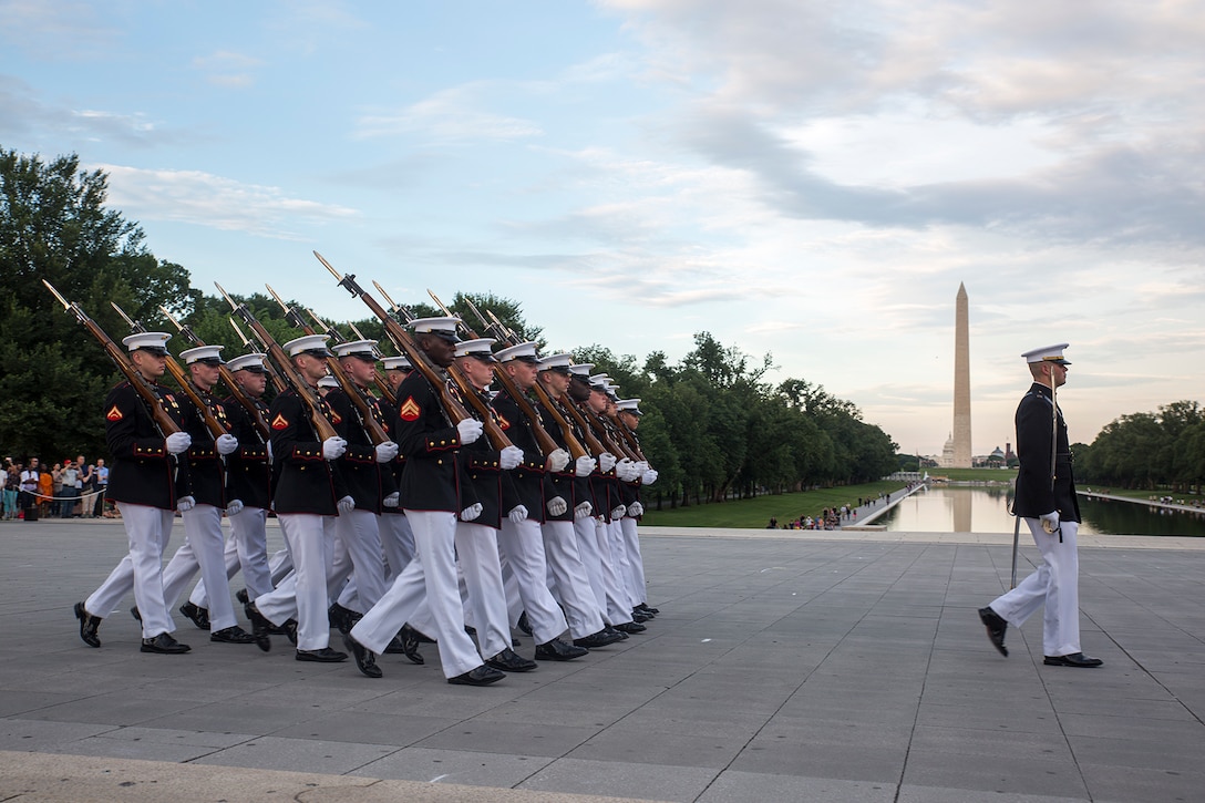 Marines with Bravo Company, Marine Barracks Washington D.C., march across the parade deck during a Tuesday Sunset Parade at the Lincoln Memorial, Washington D.C., June 19, 2018.