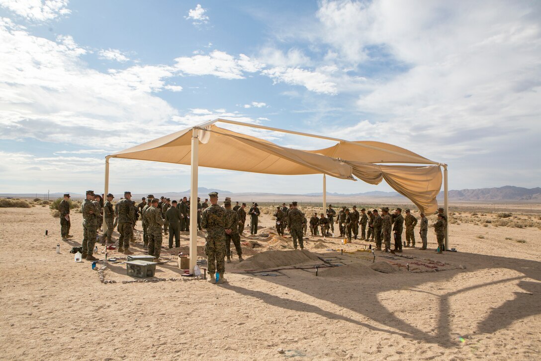 Reserve Marines with 23rd Marine Regiment, 4th Marine Division, discuss possible defensive and offensive tactics for an air assault course over a terrain model, during Integrated Training Exercise 4-18, aboard Marine Corps Air Ground Combat Center Twentynine Palms, Calif., June 15, 2018. ITX 4-18 provides Marine Air-Ground Task Force elements an opportunity to undergo service-level competency assessments so that they can seamlessly integrate with active duty Marines in the event of a crises that requires a rapid response. (U.S. Marine Corps photo by Cpl. Dallas Johnson/Released)
