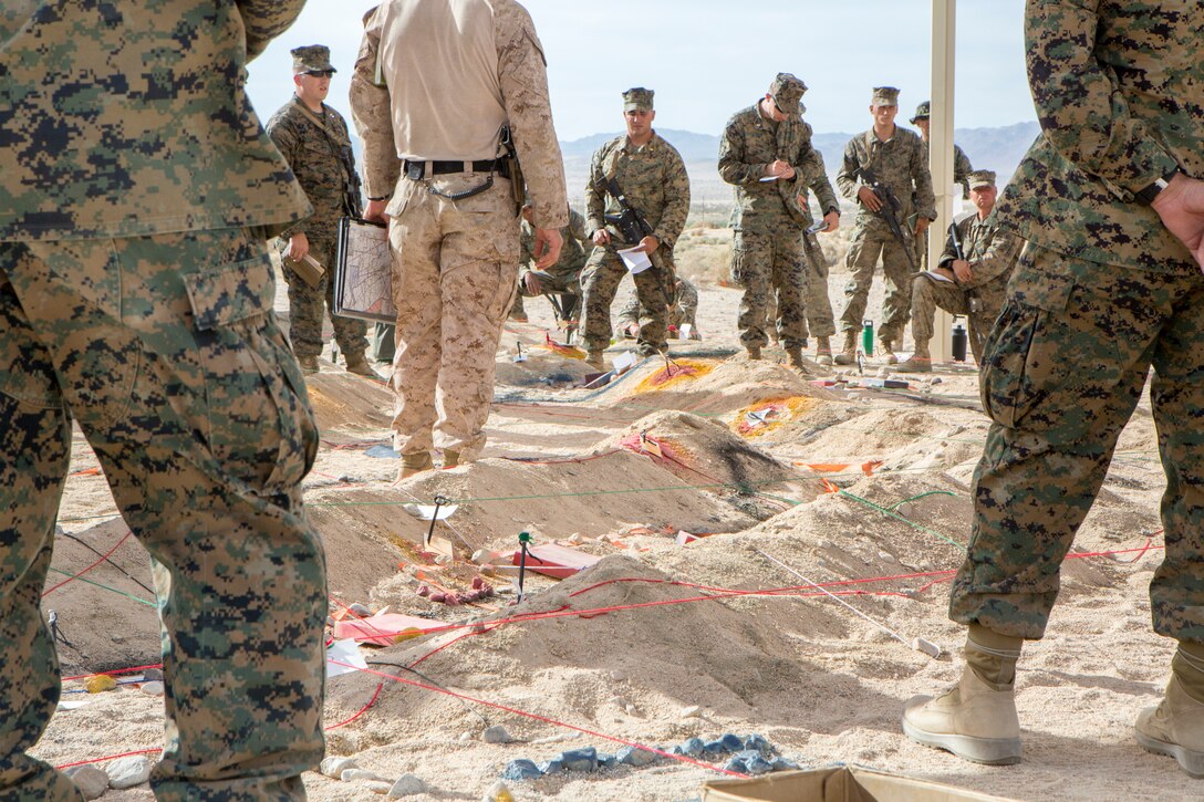 Reserve Marines with 23rd Marine Regiment, 4th Marine Division,  discuss possible defensive and offensive tactics for an air assault course, during Integrated Training Exercise 4-18, aboard Marine Corps Air Ground Combat Center Twentynine Palms, Calif., June 15, 2018. ITX 4-18 provides Marine Air-Ground Task Force elements an opportunity to undergo service-level competency assessments so that they can seamlessly integrate with active duty Marines, into a Marine Air Ground Task Force, in the event of a crises that requires a rapid response. (U.S. Marine Corps photo by Cpl. Dallas Johnson/Released)