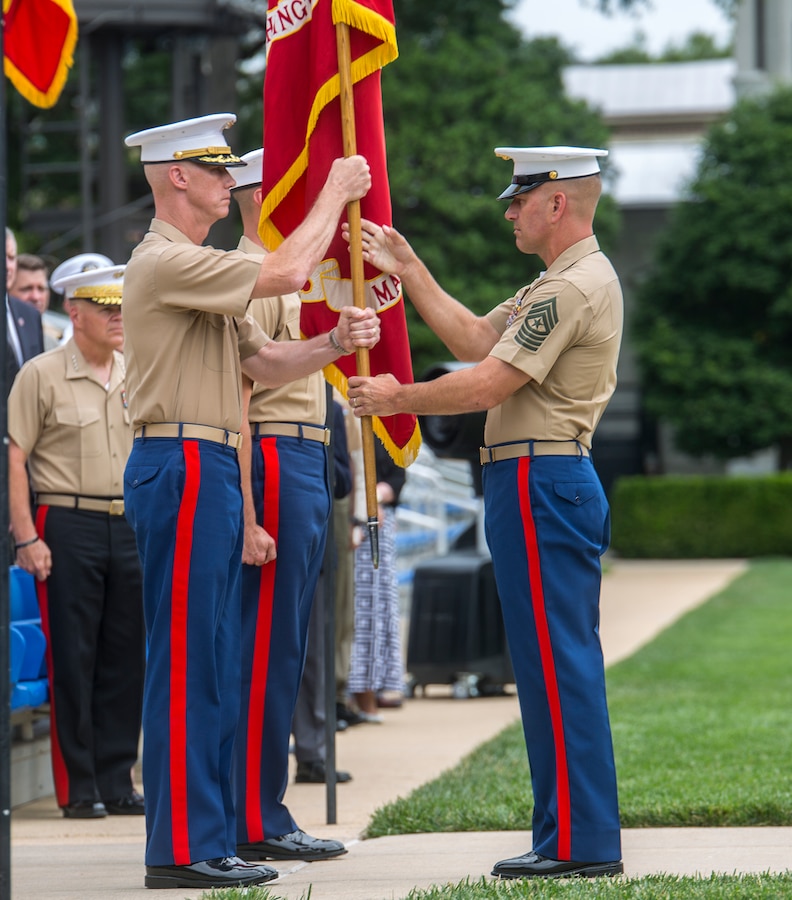 Sergeant Maj. Matthew Hackett, right, command sergeant major, Marine Barracks Washington D.C., passes off the Marine Corps Battle Colors to Col. Tyler J Zagurski, outgoing commanding officer, Marine Barracks Washington D.C., during a change of command ceremony at the Barracks, June 20, 2018. Colonel Tyler J. Zagurski relinquished his command of Marine Barracks Washington D.C. to Col. Don Tomich. Tomich previously served as the Assistant Chief of Staff for Operations, Marine Forces Central Command. (Official Marine Corps photo by Sgt. Robert Knapp/Released)
