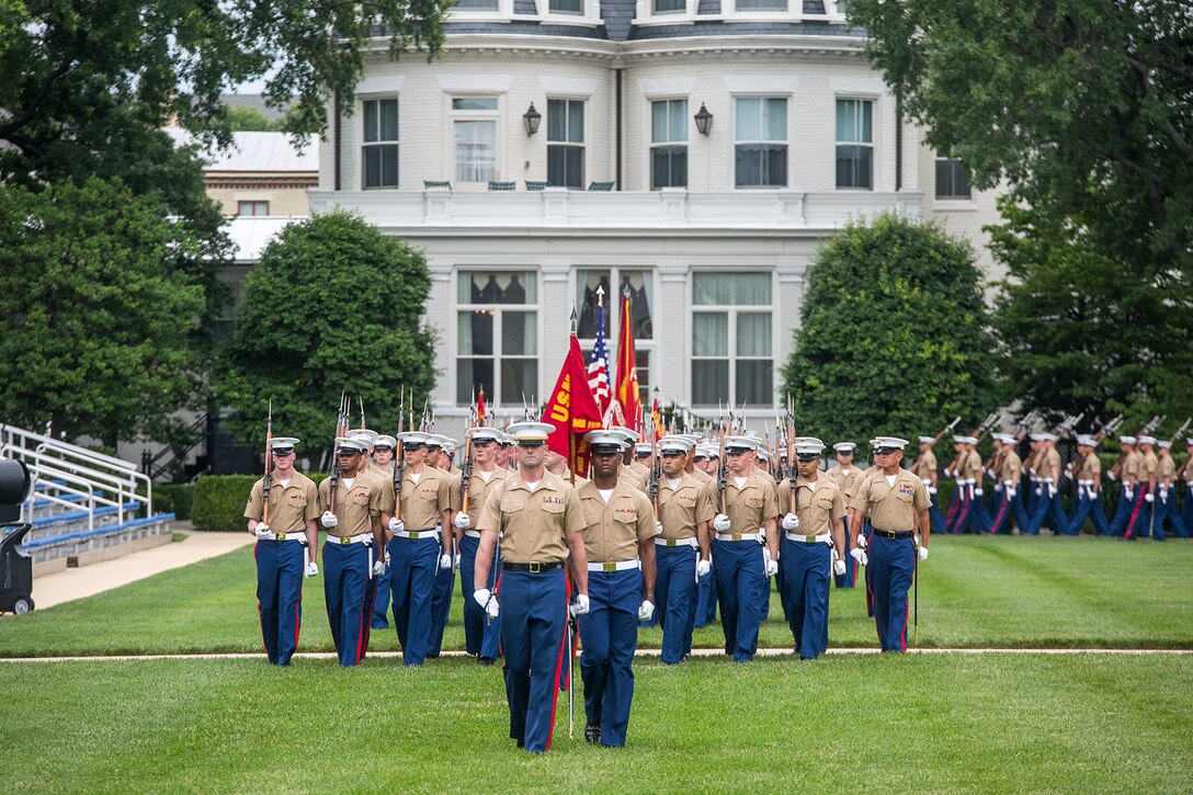 Marines with Marine Barracks Washington D.C., march across the parade deck for pass and review during a change of command ceremony at the Barracks, June 20, 2018. Colonel Tyler J. Zagurski relinquished his command of Marine Barracks Washington D.C. to Col. Don Tomich. Tomich previously served as the Assistant Chief of Staff for Operations, Marine Forces Central Command. (Official Marine Corps photo by Sgt. Robert Knapp/Released)