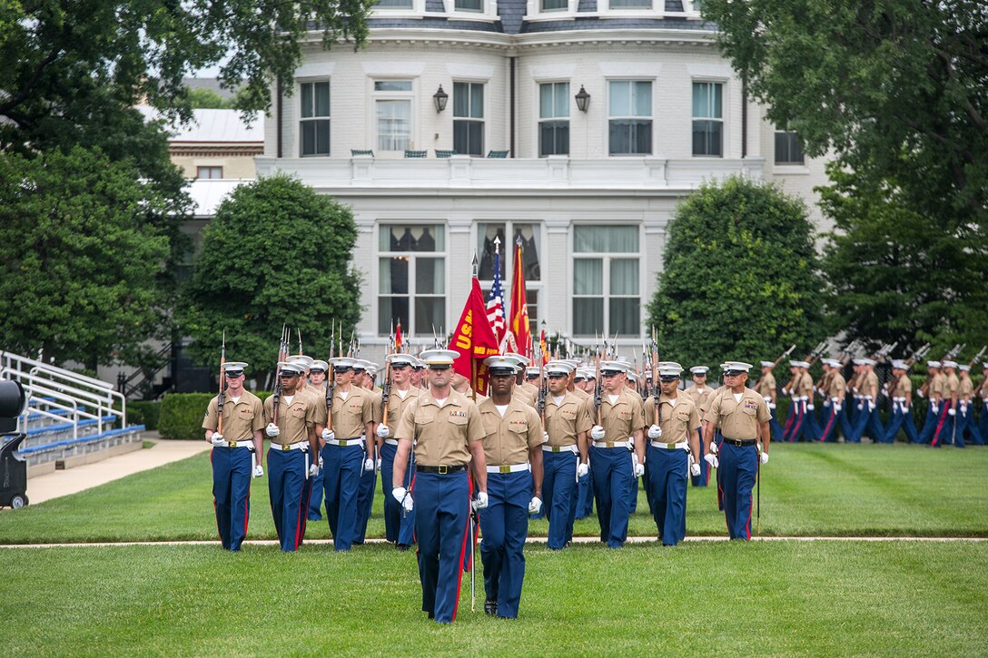 Marines with Marine Barracks Washington D.C., march across the parade deck for pass and review during a change of command ceremony at the Barracks, June 20, 2018.