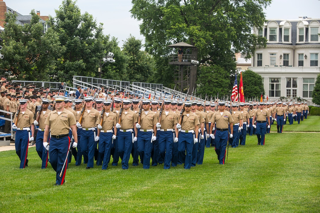 Marines with Marine Barracks Washington D.C., march across the parade deck for pass and review during a change of command ceremony at the Barracks, June 20, 2018. Colonel Tyler J. Zagurski relinquished his command of Marine Barracks Washington D.C. to Col. Don Tomich. Tomich previously served as the Assistant Chief of Staff for Operations, Marine Forces Central Command. (Official Marine Corps photo by Sgt. Robert Knapp/Released)