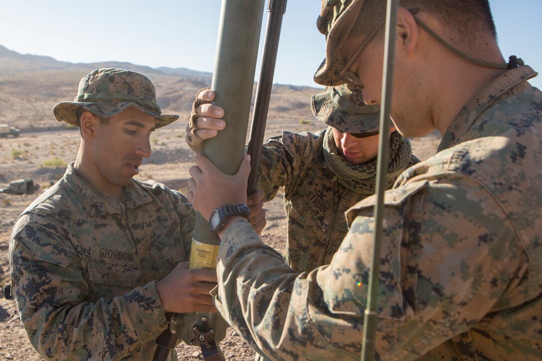Lance Cpl. Andre Giordon (left) and Lance Cpl. Benjamin Strube (center), scout observers with Battery M, 3rd Battalion, 14th Marine Regiment, 4th Marine Division, and Cpl. Jonathan Azali (right), a radio operator with 3rd Air Naval Gunfire Liaison Company, Force Headquarters Group, begin configuring a Cobham COM201B low-band VHF antenna to establish communication for leaders of Company A, 1st Battalion, 23rd Marine Regiment, 4th MARDIV, during Integrated Training Exercise 4-18, aboard Marine Corps Air Ground Combat Center Twentynine Palms, Calif., June 17, 2018. ITX 4-18 provides Marine Air-Ground Task Force elements an opportunity to undergo service-level competency assessments so that they can seamlessly integrate with active duty Marines in the event of a crises that requires a rapid response. (U.S. Marine Corps photo by Cpl. Dallas Johnson/Released)