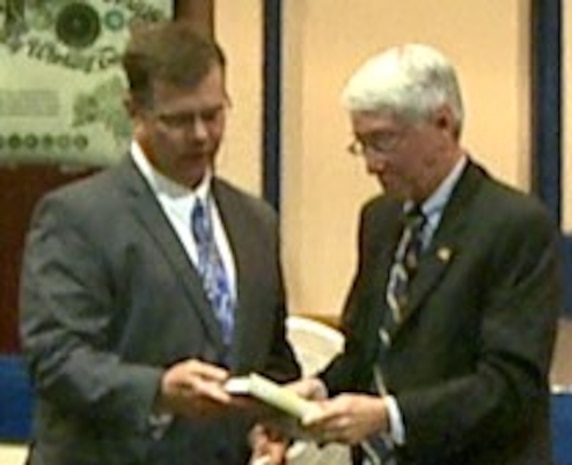 IMAGE: DAHLGREN, Va. (May 29, 2018) – Chuck Campbell, Naval Surface Warfare Center Dahlgren Division (NSWCDD) Chief of Staff, presents the Dahlgren history book, "The Sound of Freedom," and a centennial coin to Dr. Carson Eoyang in appreciation of his keynote speech at the Asian American and Pacific Islander (AAPI) Heritage Month Observance.  “The vision that President Adams had at the beginning of our country is the American dream our family has lived, and we are forever grateful that we live in the United States of America,” Eoyang told his audience at the Naval Surface Warfare Center Dahlgren Division sponsored event. (U.S. Navy photo/Released)