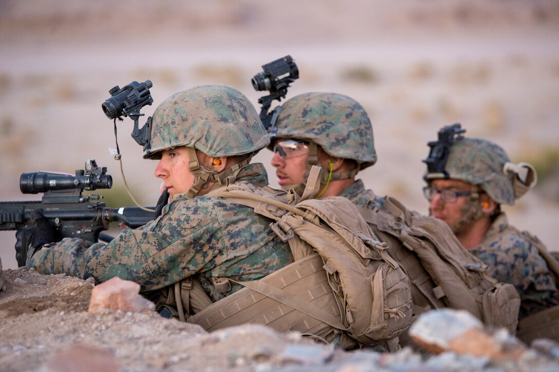 Reserve Marines with Company A, 1st Battalion, 23rd Marine Regiment, 4th Marine Division, position themselves in a foxhole prior to engaging a notional enemy during an air assault course, at Integrated Training Exercise 4-18, aboard Marine Corps Air Ground Combat Center Twentynine Palms, Calif., June 17, 2018. ITX 4-18 provides Marine Air-Ground Task Force elements an opportunity to undergo service-level competency assessments so that they can seamlessly integrate with active duty Marines, into a Marine Air Ground Task Force, in the event of a crises that requires a rapid response. (U.S. Marine Corps photo by Cpl. Dallas Johnson/Released)