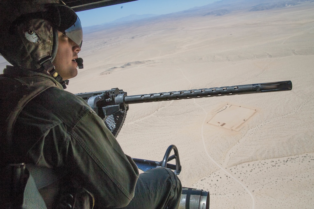 Sgt. Reyes Macedo, a helicopter crew chief with Marine Light Attack Helicopter Squadron 775, Marine Aircraft Group 41, 4th Marine Aircraft Wing, acquires a BDM, Soviet airborne amphibious tracked infantry fighting vehicle, target while conducting a close air support mission, during Integrated Training Exercise 4-18 at Marine Corps Air Ground Combat Center Twentynine Palms, Calif., June 18, 2018. HMLA-775, also known as the “Coyotes”, provided air combat element support to Marine Air Ground Task Force 23 during ITX 4-18. (U.S. Marine Corps photo by Lance Cpl. Samantha Schwoch/released)