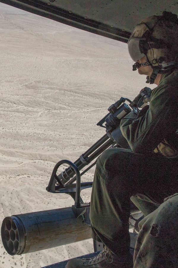 Staff Sgt. Andrew Weanie, a helicopter crew chief with Marine Light Attack Helicopter Squadron 775, Marine Aircraft Group 41, 4th Marine Aircraft Wing, acquires a BDM, Soviet airborne amphibious tracked infantry fighting vehicle, target while conducting a close air support mission, during Integrated Training Exercise 4-18 at Marine Corps Air Ground Combat Center Twentynine Palms, Calif., June 18, 2018. HMLA-775, also known as the “Coyotes," provided air combat element support to Marine Air Ground Task Force 23 during ITX 4-18. (U.S. Marine Corps photo by Lance Cpl. Samantha Schwoch/released)