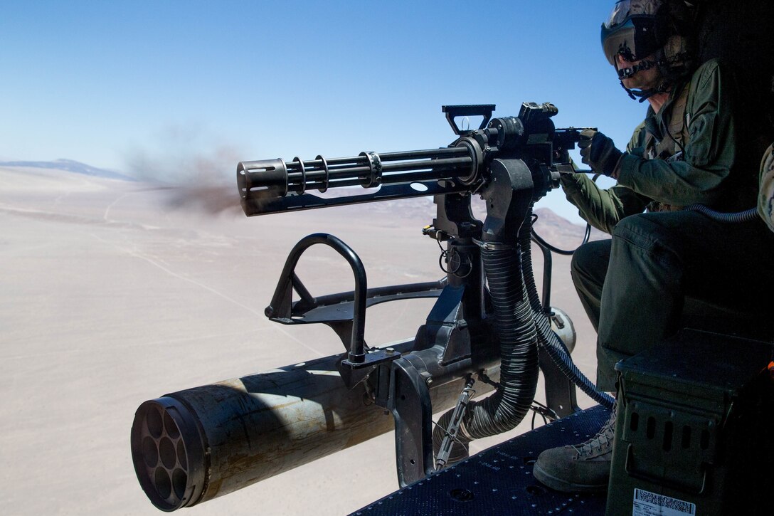 Staff Sgt. Andrew Weanie, a helicopter crew chief with Marine Light Attack Helicopter Squadron 775, Marine Aircraft Group 41, 4th Marine Aircraft Wing, fires a GAU-17 while conducting a close air support mission during Integrated Training Exercise 4-18 at Marine Corps Air Ground Combat Center Twentynine Palms, Calif., June 18, 2018. HMLA-775, also known as the “Coyotes”, provided air combat element support to Marine Air Ground Task Force 23 during ITX 4-18. (U.S. Marine Corps photo by Lance Cpl. Samantha Schwoch/released)