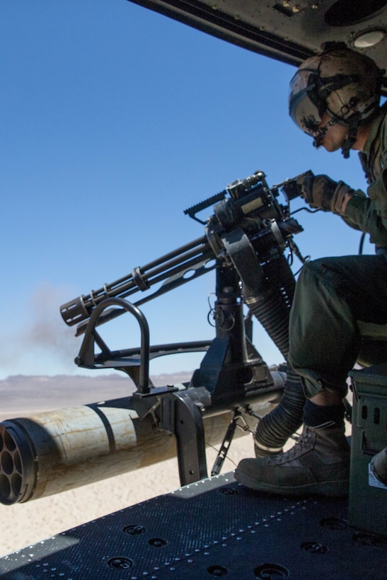 Staff Sgt. Andrew Weanie, a helicopter crew chief with Marine Light Attack Helicopter Squadron 775, Marine Aircraft Group 41, 4th Marine Aircraft Wing, fires a GAU-17 while conducting a close air support mission, during Integrated Training Exercise 4-18 at Marine Corps Air Ground Combat Center Twentynine Palms, Calif., June 18, 2018. HMLA-775, also known as the “Coyotes," provided air combat element support to Marine Air Ground Task Force 23 during ITX 4-18. (U.S. Marine Corps photo by Lance Cpl. Samantha Schwoch/released)