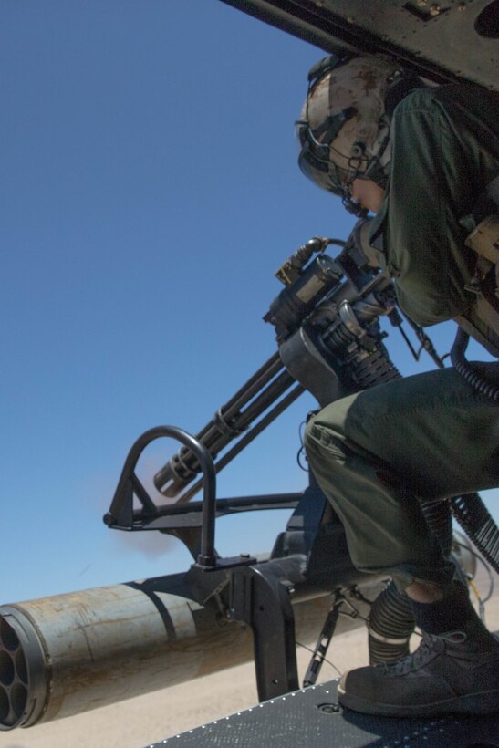 Staff Sgt. Andrew Weanie, a helicopter crew chief with Marine Light Attack Helicopter Squadron 775, Marine Aircraft Group 41, 4th Marine Aircraft Wing, fires a GAU-17 while conducting a close air support mission, during Integrated Training Exercise 4-18 at Marine Corps Air Ground Combat Center Twentynine Palms, Calif., June 18, 2018. HMLA-775, also known as the “Coyotes," provided air combat element support to Marine Air Ground Task Force 23 during ITX 4-18. (U.S. Marine Corps photo by Lance Cpl. Samantha Schwoch/released)