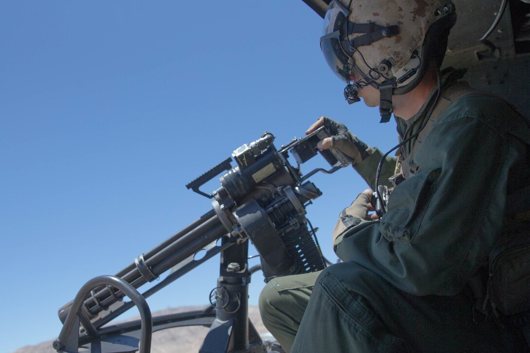 Staff Sgt. Andrew Weanie, a helicopter crew chief with Marine Light Attack Helicopter Squadron 775, Marine Aircraft Group 41, 4th Marine Aircraft Wing, observes the acquired targets during a close air support mission, during Integrated Training Exercise 4-18 at Marine Corps Air Ground Combat Center Twentynine Palms, Calif., June 18, 2018. HMLA-775, also known as the “Coyotes," provided air combat element support to Marine Air Ground Task Force 23 during ITX 4-18. (U.S. Marine Corps photo by Lance Cpl. Samantha Schwoch/released)