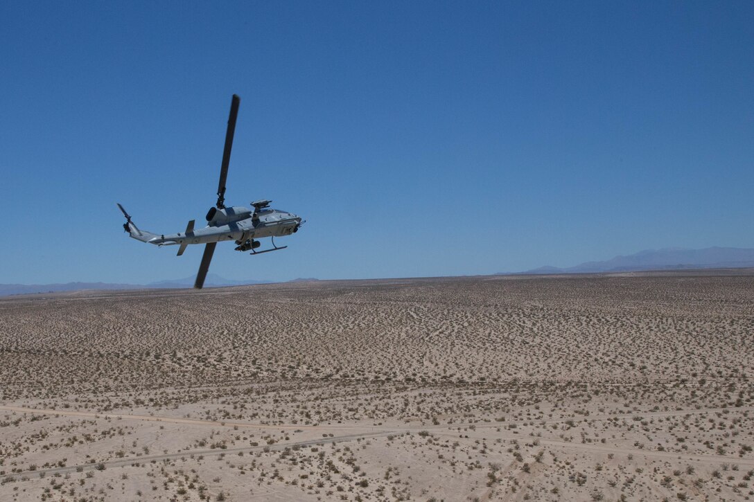 An AH-1W SuperCobra, with Marine Light Attack Helicopter Squadron 775, Marine Aircraft Group 41, 4th Marine Aircraft Wing, performs a break turn after conducting a close air support mission, during Integrated Training Exercise 4-18 at Marine Corps Air Ground Combat Center Twentynine Palms, Calif., June 18, 2018. HMLA-775, also known as the “Coyotes," provided air combat element support to Marine Air Ground Task Force 23 during ITX 4-18. (U.S. Marine Corps photo by Lance Cpl. Samantha Schwoch/released)