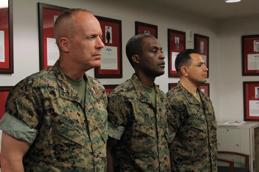 USAG CAMP HUMPHREYS – Maj. Gen. Patrick J. Hermesmann (left), commander of U.S. Marine Corps Forces Korea, Petty Officer 1st Class Andre C. Cooper (center), head medical representative for MARFORK, and Master Sgt. Rene G. Navarro (right), G3 Operations chief, lead celebration for the 120th Birthday of the U.S. Navy Hospital Corps.  Cooper thanked the command for taking the time to recognize the contributions of corpsmen to the service, cut a birthday cake commemorating the event and shared it with the Marines of the command. (Official U.S. Marine Corps photo by Sgt. Nathaniel Hanscom/released)