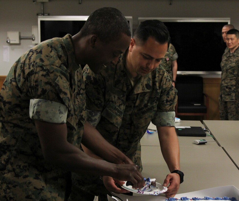 USAG CAMP HUMPHREYS – Petty Officer 1st Class Andre C. Cooper (left), head medical representative for MARFORK, and Master Sgt. Rene G. Navarro, G3 Operations chief, cut a birthday cake in celebration of the 120th Birthday of the U.S. Navy Hospital Corps.  Cooper thanked the command for taking the time to recognize the contributions of corpsmen to the service, and shared the cake with the Marines of the command. (Official U.S. Marine Corps photo by Sgt. Nathaniel Hanscom/released)