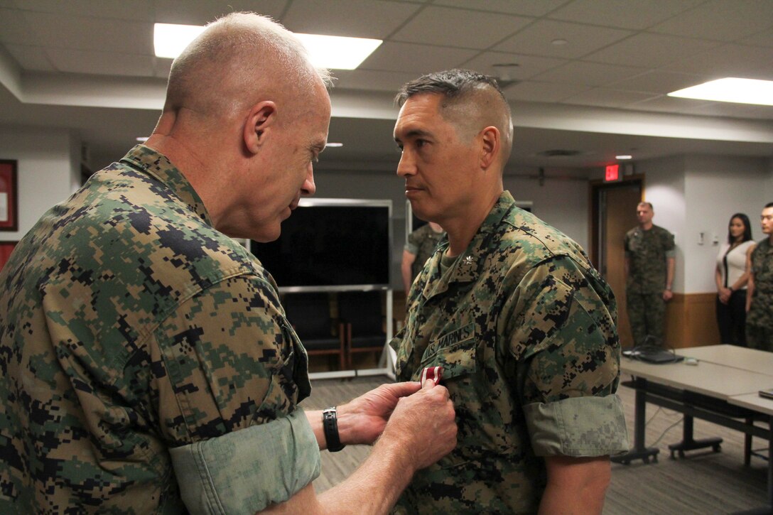 USAG CAMP HUMPHREYS, Korea – Maj. Gen. Patrick J. Hermesmann (left), commander of U.S. Marine Corps Forces Korea, awards Lt. Col. Sam L. Roy, MARFORK G3 deputy assistant chief of staff for operations and current operations officer, the Meritorious Service Medal for his outstanding contributions to the unit here, June 13. Roy led the operations section through four major exercises and periods of heightened tension.  (Official U.S. Marine Corps photo by Sgt. Nathaniel Hanscom/ Released)