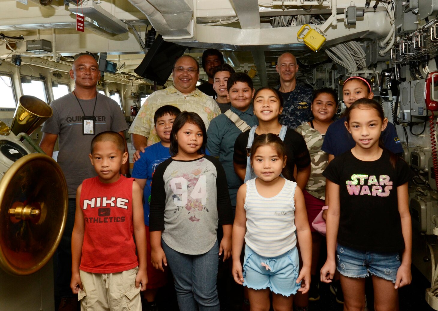 Capt. Jeff Farah, commanding officer of the submarine tender USS Frank Cable (AS 40), poses for a group photo with the Mayor of Piti, Jesse Alig, and students from various schools participating in the Piti Summer Program during a ship tour, June 18. Frank Cable, forward-deployed to the island of Guam, repairs, rearms and reprovisions submarines and surface vessels in the Indo-Pacific region.