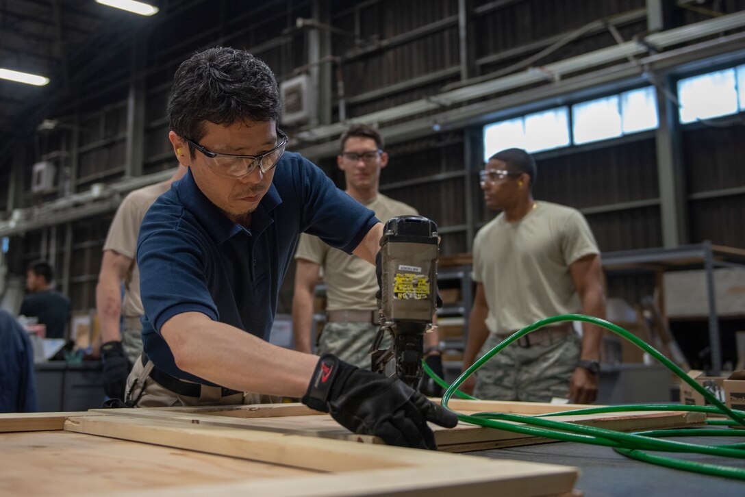 A member of the 374th Logistics Readiness Squadron demonstrates the proper technique for utilizing a staple gun as part of the Wing Immersion Program at Yokota Air Base, Japan, June 20, 2018.