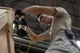 Airman 1st Class Boaz Rogel, 374th Security Forces Squadron patrolman, nails the base of a container into place during the Wing Immersion Program at Yokota Air Base, Japan, June 20, 2018.