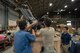 Members of the 374th Logistics Readiness Squadron and 374th Security Forces Squadron work together to load a seat into a packing container for shipment during the Wing Immersion Program at Yokota Air Base, Japan, June 20, 2018.