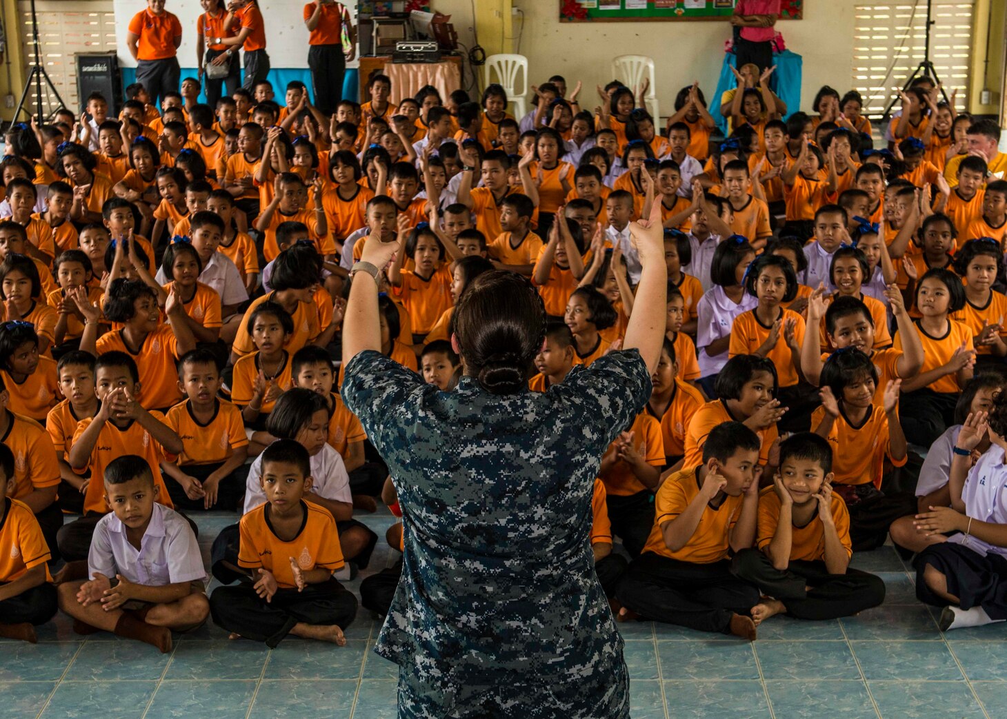 Navy Musician 2nd Class Emily Kershaw, assigned to the U.S. 7th Fleet Band, performs for local children at Ban Charknok primary school during Cooperation Afloat Readiness and Training (CARAT) Thailand 2018. The CARAT exercise series, in its 24th iteration, highlights the skill and will of regional partners to cooperatively work together towards the common goal of ensuring a secure and stable maritime environment.