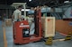 Tech. Sgt. Edwin Jacobo, 374th Logistics Readiness Squadron NCO in charge of outbound cargo, directs Airman 1st Class Boaz Rogel, 374th Security Forces Squadron patrolman, as he maneuvers a package onto a scale to be weighed before shipment during the Wing Immersion program at Yokota Air Base, Japan, June 20, 2018.