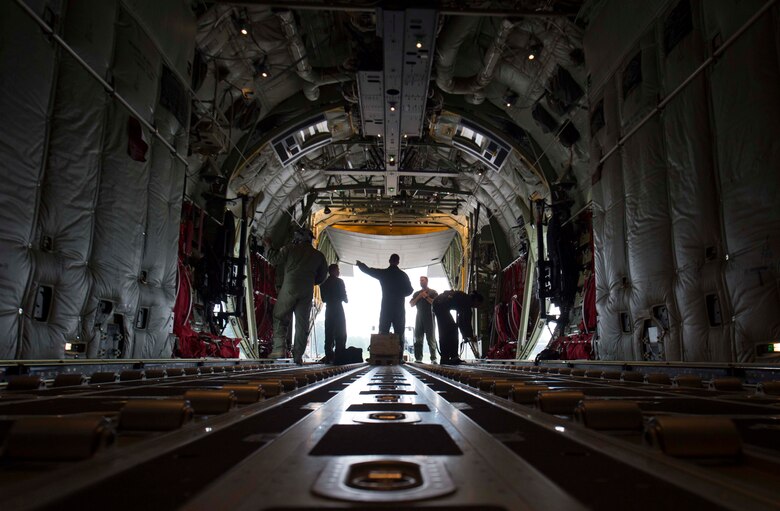 Loadmasters assigned to the 37th Airlift Squadron stand in the back of a C-130J Super Hercules aircraft on Ramstein Air Base, Germany, June 12, 2018. Aircraft loadmasters are responsible for properly loading, securing, and escorting cargo and passengers. (U.S. Air Force photo by Senior Airman Elizabeth Baker)