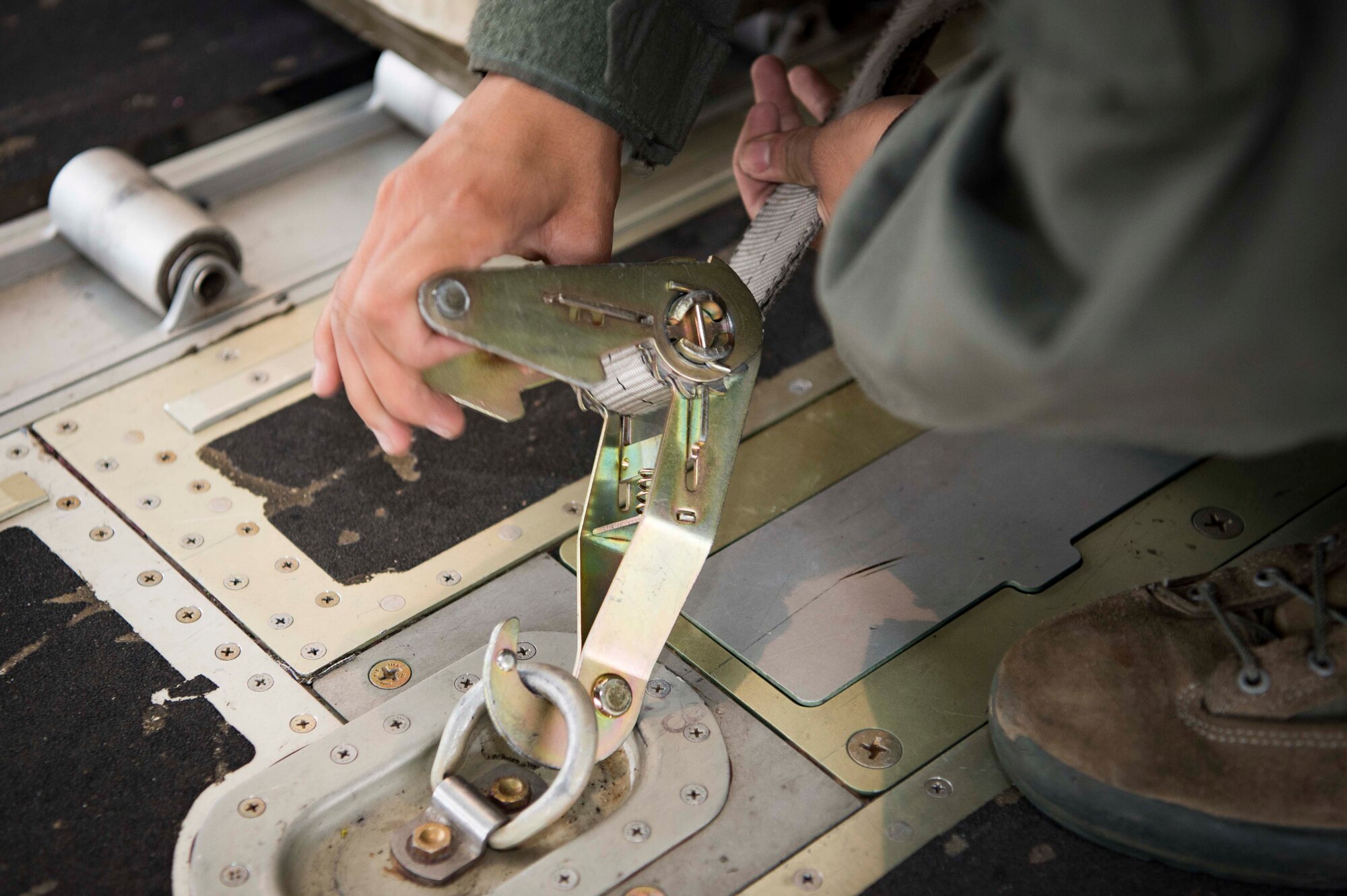 U.S. Air Force Senior Airman Vanessa Soriano-Cervantes, 37th Airlift Squadron C-130J Super Hercules aircraft loadmaster, secures cargo for transport inside a C-130J on Ramstein Air Base, Germany, June 12, 2018. Loadmasters are responsible for ensuring that all cargo and personnel arrive safely at their destinations, making them a key player in Ramstein's airlift mission. (U.S. Air Force photo by Senior Airman Elizabeth Baker)