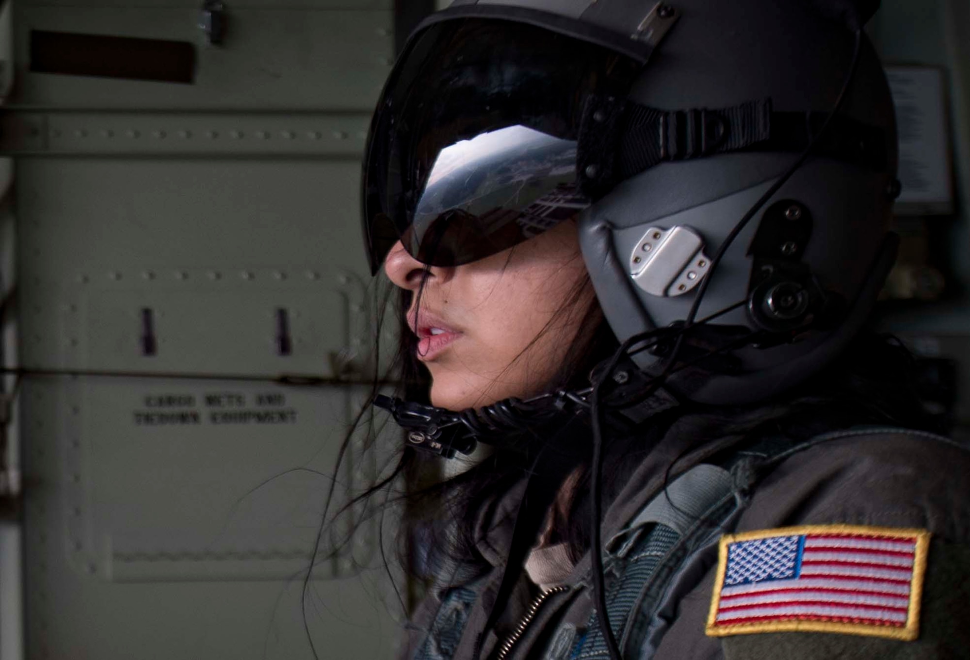U.S. Air Force Senior Airman Vanessa Soriano-Cervantes, 37th Airlift Squadron C-130J Super Hercules aircraft loadmaster, waits for permission from the flight commander to release cargo over an airfield in Germany, June 12, 2018. Ramstein's loadmasters practice air drops regularly to ensure they are able to deliver essential cargo such as water and food to deployed locations. (U.S. Air Force photo by Senior Airman Elizabeth Baker)