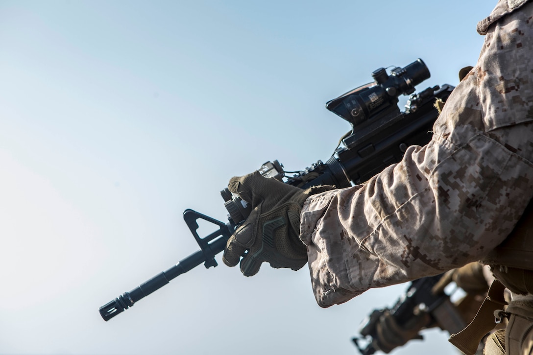 A U.S. Marine assigned to Battalion Landing Team, 2nd Battalion, 6th Marine Regiment, 26th Marine Expeditionary Unit, stands-by for firing commands during a live-fire deck shoot onboard the amphibious assault ship USS Iwo Jima, in the U.S. 5th fleet area of operations, June 19, 2018. Iwo Jima and the 26th MEU are conducting naval operations in the U.S. 5th Fleet area of operations.