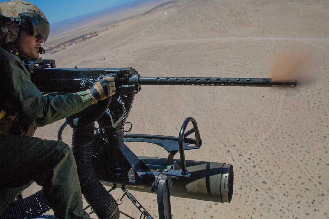 Sgt. Reyes Macedo, a helicopter crew chief with Marine Light Attack Helicopter Squadron 775, Marine Aircraft Group 41, 4th Marine Aircraft Wing, fires a GAU-21 while conducting a close air support mission, during Integrated Training Exercise 4-18 at Marine Corps Air Ground Combat Center Twentynine Palms, Calif., June 18, 2018. HMLA-775, also known as the “Coyotes," provided air combat element support to Marine Air Ground Task Force 23 during ITX 4-18.