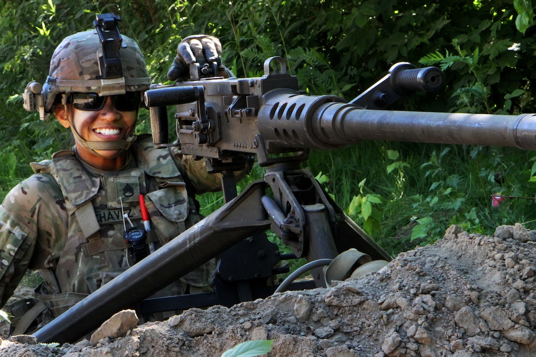 A soldier takes a break from providing security with a .50-caliber machine gun.