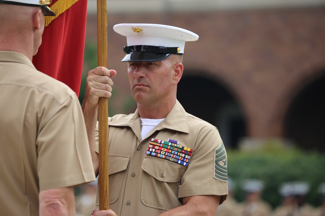 Sergeant Maj. Matthew Hackett, command sergeant major, Marine Barracks Washington D.C., passes off the Marine Corps Battle Colors to Col. Tyler J Zagurski, outgoing commanding officer, Marine Barracks Washington D.C., during a change of command ceremony at the Barracks, June 20, 2018. Colonel Tyler J. Zagurski relinquished his command of Marine Barracks Washington D.C. to Col. Don Tomich. Tomich previously served as the Assistant Chief of Staff for Operations, Marine Forces Central Command.
