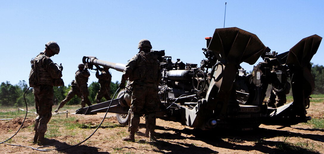 Soldiers set up a howitzer before conducting a live-fire training exercise.