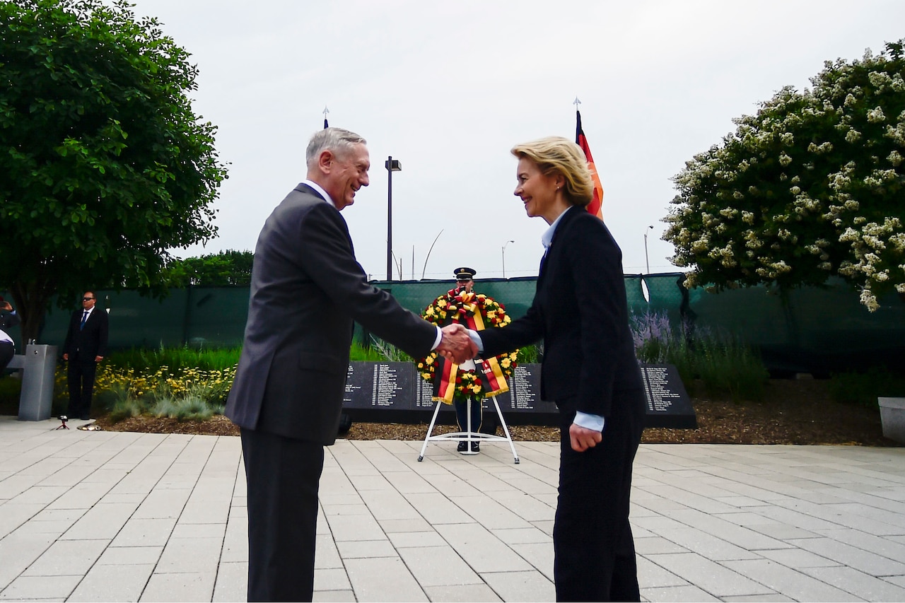 U.S. and German defense leaders shake hands.