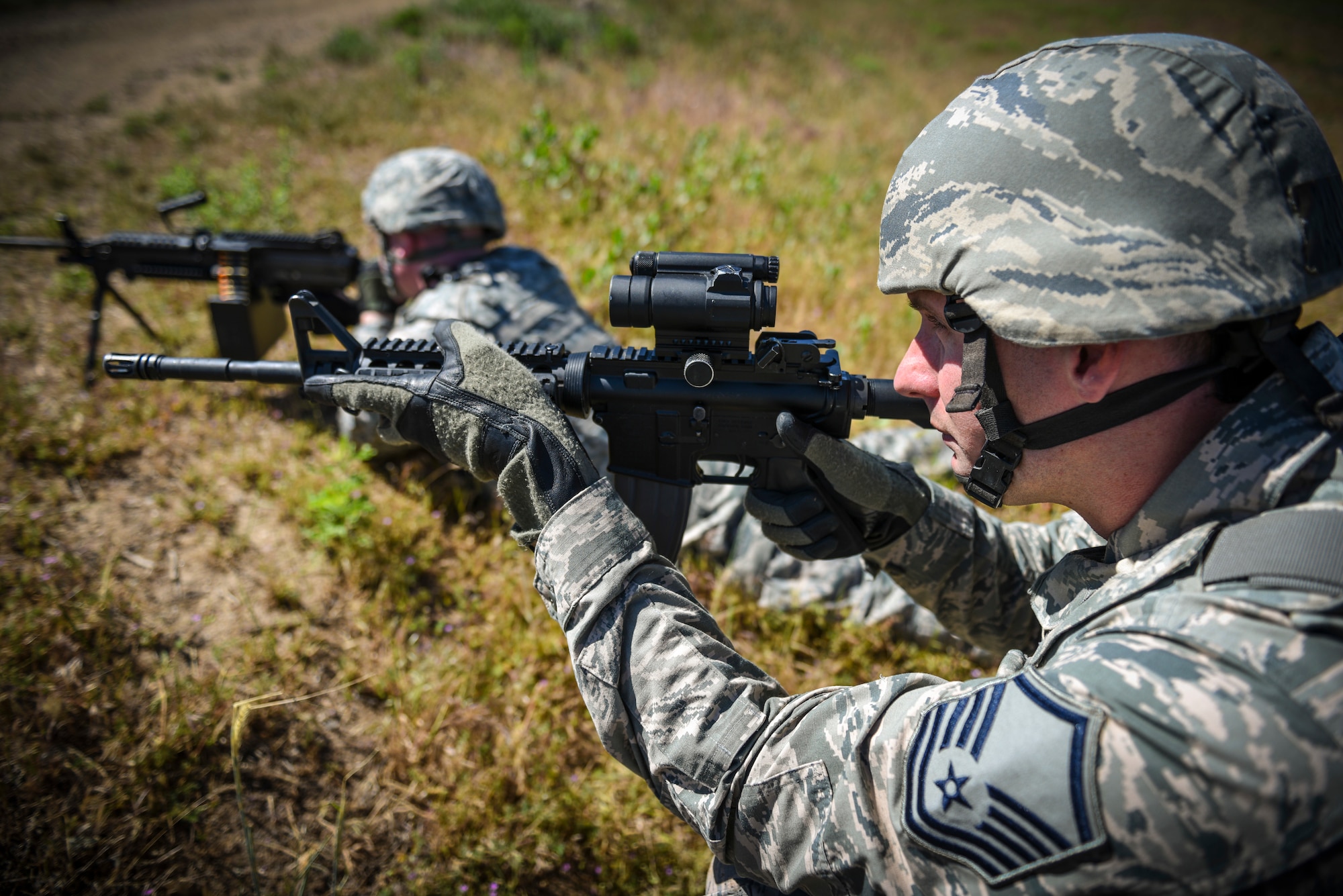 Staff Sgt. Robert Brinton and Master Sgt. David Hasseler, 419th Security Forces Squadron, take aim down range