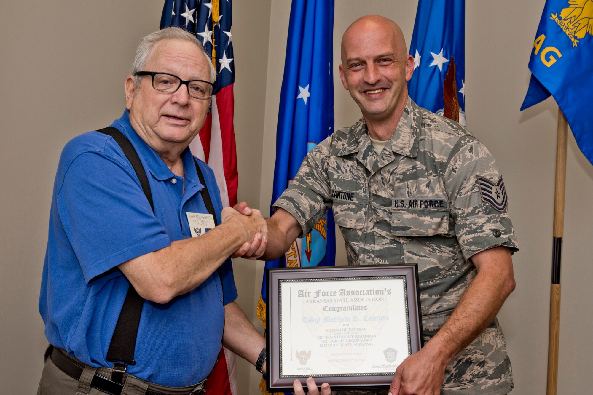 U.S. Air Force Reserve  Tech. Sgt. Matthew Cantone, services technician, 913th Force Support Squadron, and Jerry Reichenbach, the President of the Air Force Association of Arkansas, pose for a photo at Little Rock Air Force Base, Ark., June 21, 2018.
