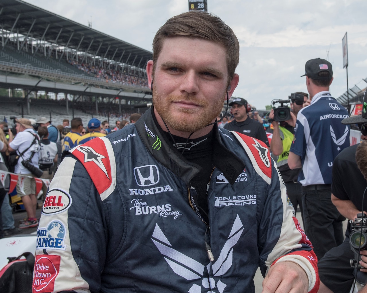 Conor Daly, driver of the No. 17 U.S. Air Force Recruiting Service Thom Burns Racing Honda, prepares to put on his helmet on pit road during "bump day" at Indianapolis Motor Speedway.