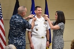 U.S. Navy Vice Adm. Dave Kriete (center), incoming deputy commander of U.S. Strategic Command (USSTRATCOM), receives his new rank insignia from his wife Kathleen (right) and Vice Adm. Charles Richard, outgoing USSTRATCOM deputy commander, during a ceremony at Offutt Air Force Base, Neb., June 15, 2018. Following his promotion, Kriete replaced Richard as USSTRATCOM deputy commander. He previously served as the National Security Council director of strategic capabilities policy. U.S. Strategic Command has global responsibilities assigned through the Unified Command Plan that include strategic deterrence, nuclear operations, space operations, joint electromagnetic spectrum operations, global strike, missile defense, and analysis and targeting.