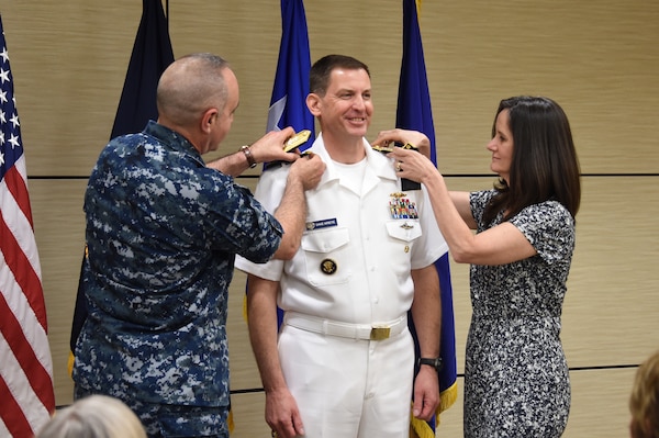 U.S. Navy Vice Adm. Dave Kriete (center), incoming deputy commander of U.S. Strategic Command (USSTRATCOM), receives his new rank insignia from his wife Kathleen (right) and Vice Adm. Charles Richard, outgoing USSTRATCOM deputy commander, during a ceremony at Offutt Air Force Base, Neb., June 15, 2018. Following his promotion, Kriete replaced Richard as USSTRATCOM deputy commander. He previously served as the National Security Council director of strategic capabilities policy. U.S. Strategic Command has global responsibilities assigned through the Unified Command Plan that include strategic deterrence, nuclear operations, space operations, joint electromagnetic spectrum operations, global strike, missile defense, and analysis and targeting.