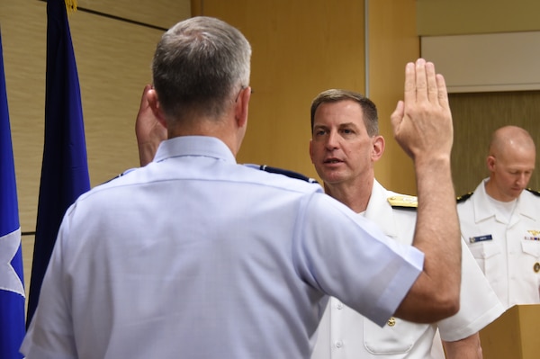 U.S. Navy Vice Adm. Dave Kriete (center), deputy commander of U.S. Strategic Command (USSTRATCOM), recites the oath of office during his promotion ceremony at Offutt Air Force Base, Neb., June 15, 2018. U.S. Air Force Gen. John Hyten (left), commander of USSTRATCOM, presided over the ceremony. Following his promotion, Kriete replaced Vice Adm. Charles Richard as USSTRATCOM deputy commander. He previously served as the National Security Council director of strategic capabilities policy. U.S. Strategic Command has global responsibilities assigned through the Unified Command Plan that include strategic deterrence, nuclear operations, space operations, joint electromagnetic spectrum operations, global strike, missile defense, and analysis and targeting.