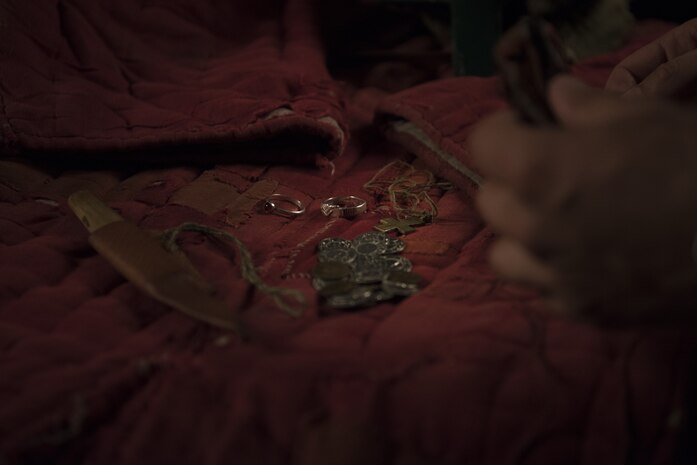 U.S. Air Force Senior Airman Benjamin Lanteigne, 628th Security Forces Squadron patrolman, shows his jewelry and weapons June 14, 2018.