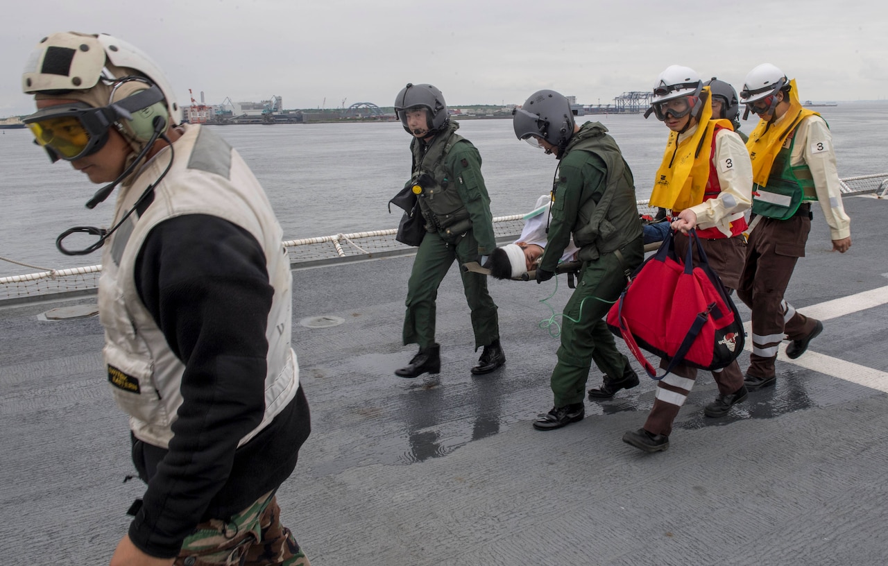 Sailors assigned to Military Sealift Command hospital ship USNS Mercy (T-AH 19) for Pacific Partnership 2018 (PP18) and Japanese Maritime Self-Defense Force (JMSDF) transfer a mock patient from an SH-60K Sea Hawk helicopter attached to the JMSDF during a bilateral medical training team drill between Mercy and JMSDF personnel. USNS Mercy is making port visits to Yokosuka and Tokyo to promote relationships between U.S. Navy Sailors and Japanese citizens through cultural exchange and bilateral training.