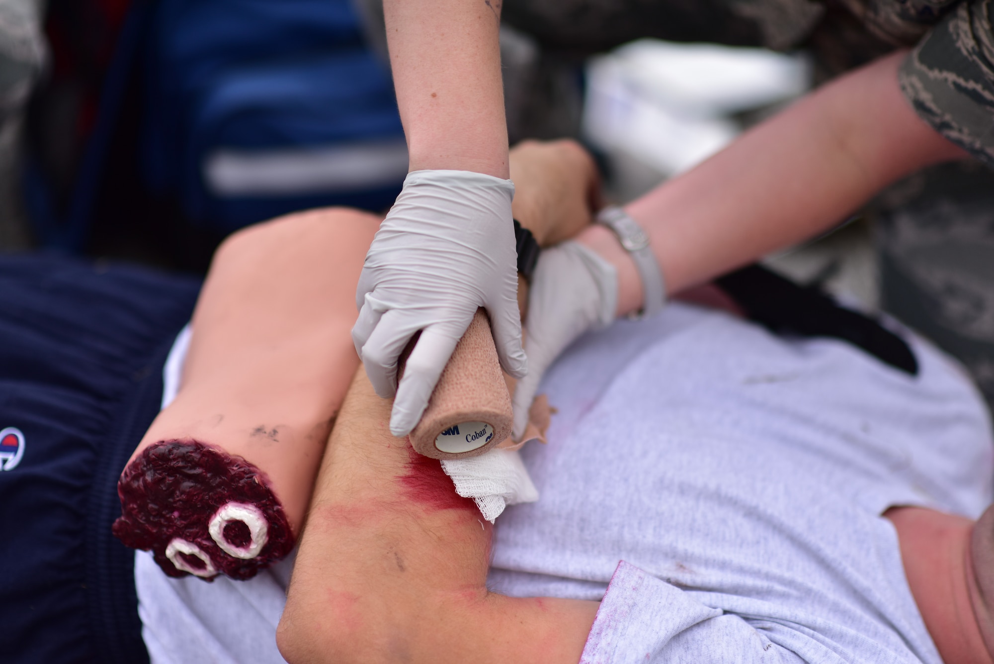 Members from the 166th Medical Squadron Squadron provide first aid care to a patient during a suspicious package training event at New Castle Air National Guard Base, Del., June 21, 2018.The training provided an opportunity to train and execute emergency response procedures in the event a suspicious package were reported on base. (U.S. Air National Guard photo by Senior Airman Katherine Miller)