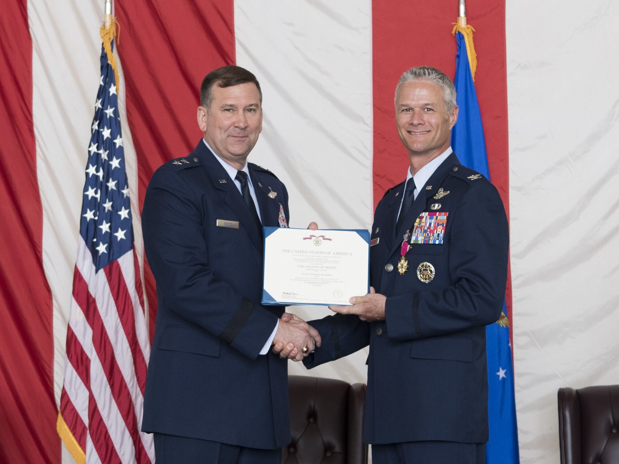Maj. Gen. Christopher Bence, U.S. Air Force Expeditionary Center commander, presents Col. Charles Henderson with the Legion of Merit during the change of command ceremony where Henderson relinquished command of the 621 CRW to Marshall here June 21.