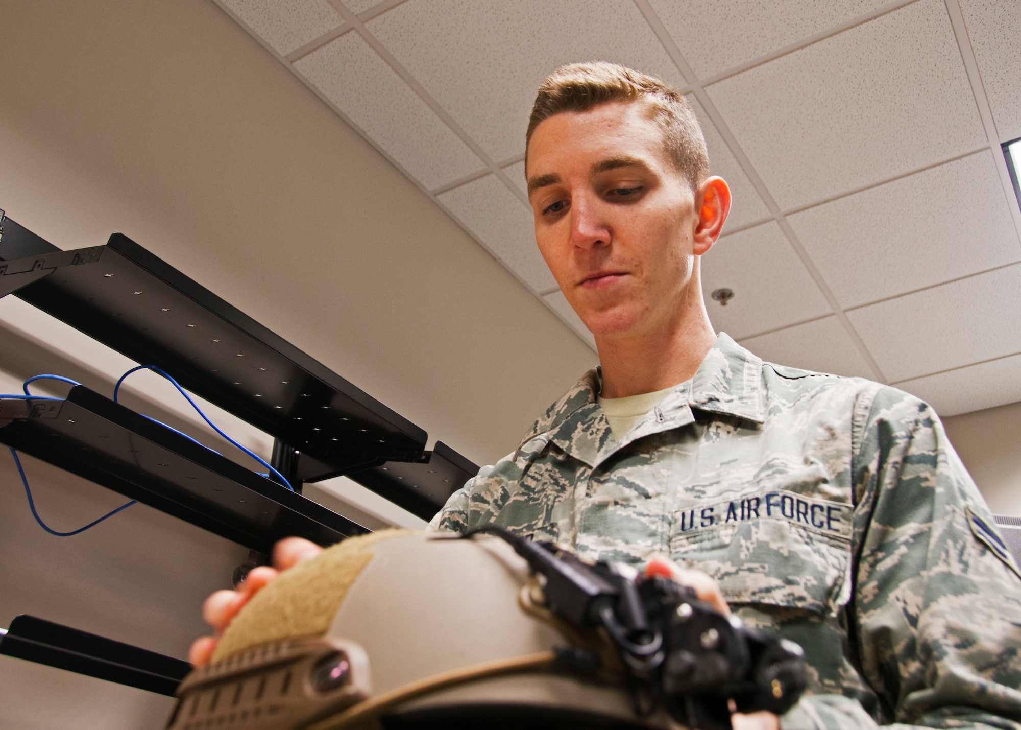 Airman 1st Class Stephen Lowmiller, a 919th Special Operations Support Squadron aircrew flight equipment journeyman, inspects an Ops-Core helmet in his workcenter at Duke Field, Fla. recently.