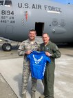During a recent visit to McChord Field, Col. Sean P. Pierce, 446th Airlift Wing commander, pauses for a photo with Air Force Chief of Staff Gen. David L. Goldfein holding the U.S. Air Force triathlon jersey. Pierce competed in the Armed Forces Triathlon Championship and the Air Force team won a silver medal. (Courtesy photo)