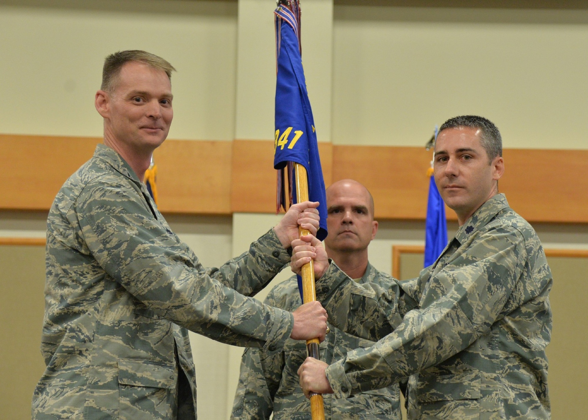 Lt. Col. Scott Schlegelmilch, right, accepts command of the 341st Missile Maintenance Squadron from Col. David Miller, 341st Maintenance Group commander, during a change of command ceremony June 21, 2018, at the Grizzly Bend at Malmstrom Air Force Base, Mont. Guidon bearer Senior Master Sgt. Robert Taylor, 341st MMXS first sergeant, looks on. (U.S. Air Force photo by Airman 1st Class Jacob M. Thompson)